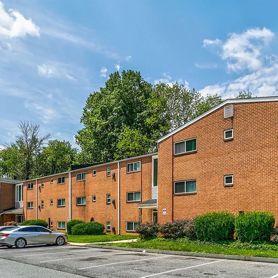 Brick apartment building with a green lawn